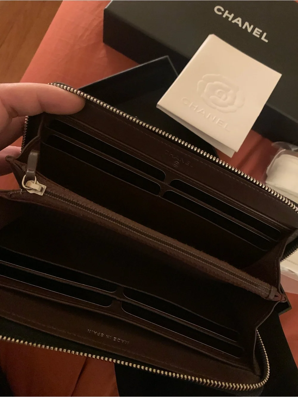 CHANEL Black Chevron Zip Around Wallet with Silver CC Emblem